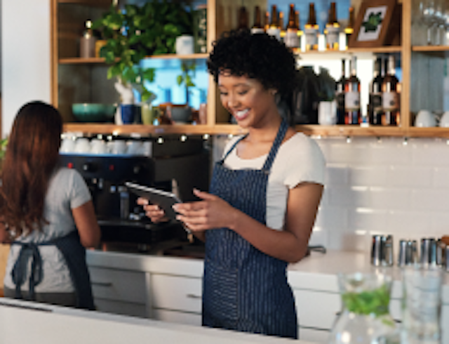 barista looking at tablet