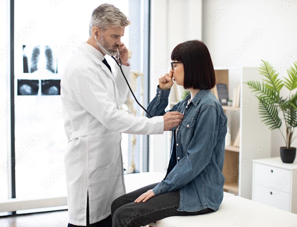 a doctor asking a patient to cough so he can listen to her chest