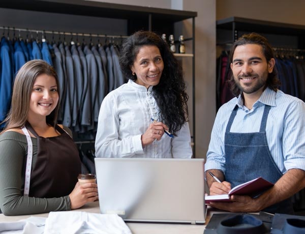 Three workers in a retail store.