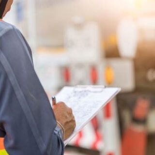 a man writing on a clipboard