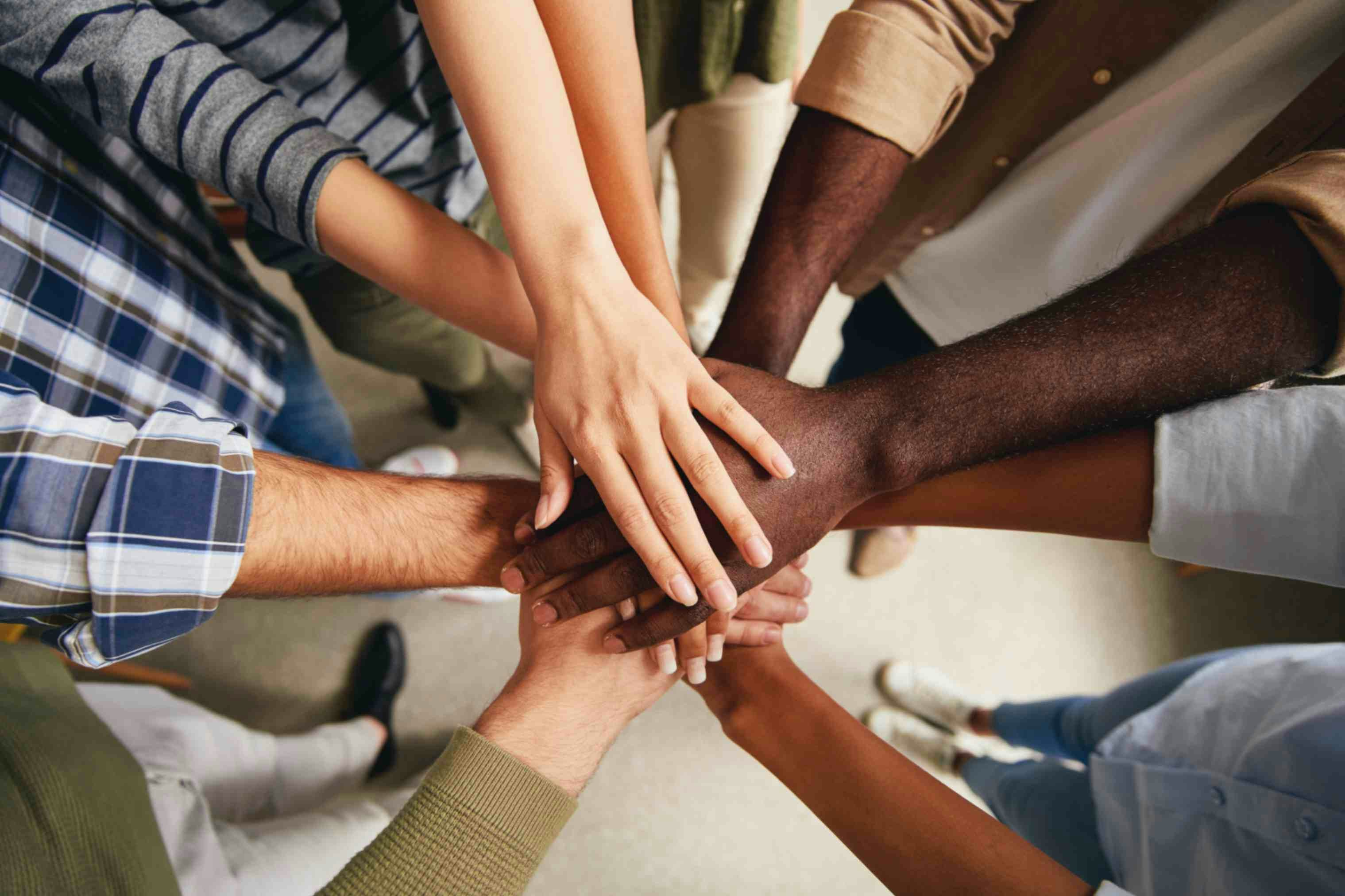 hands in frame belonging to people of all ethnicities