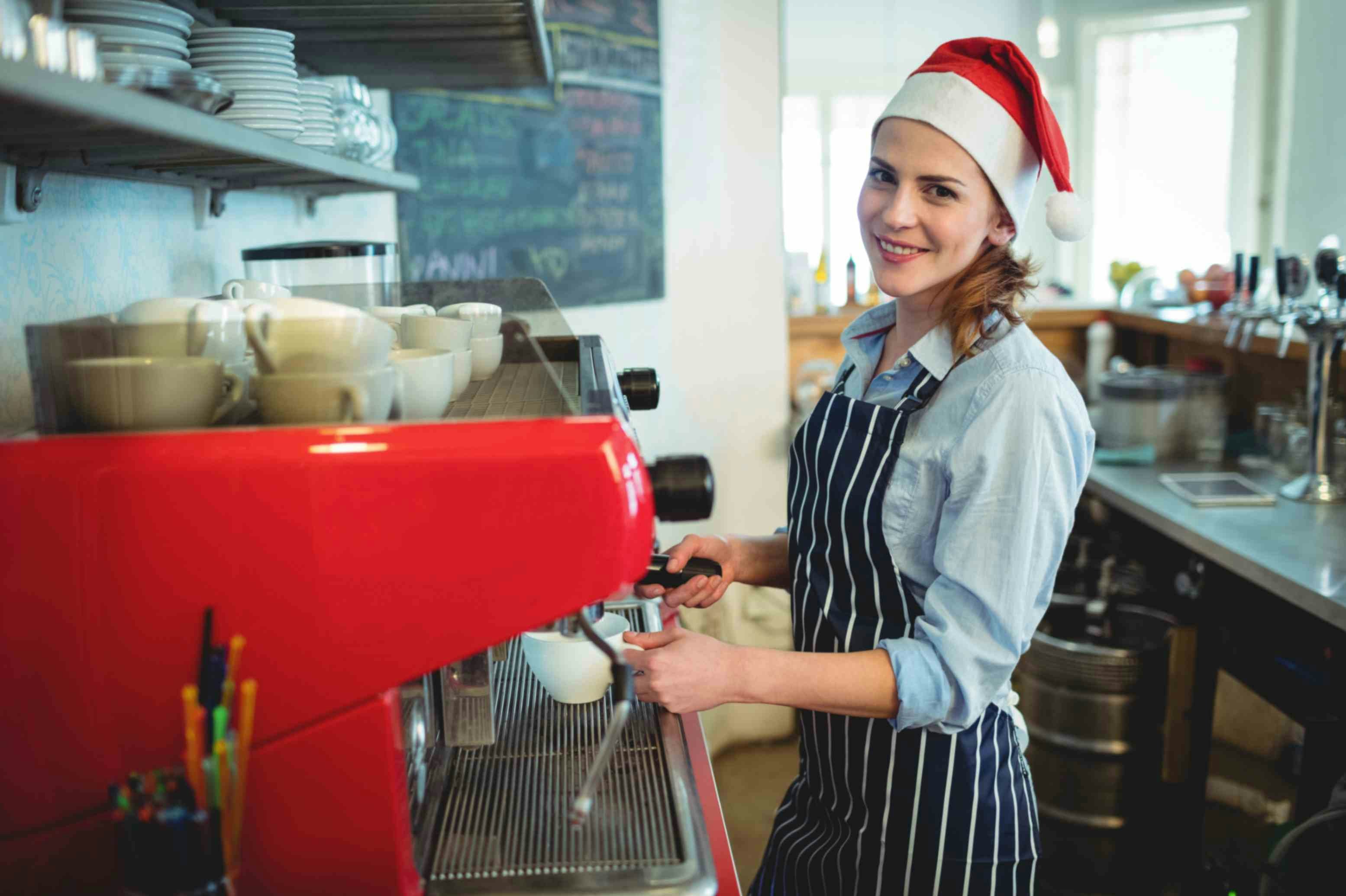 a woman in an apron wearing a christmas hat