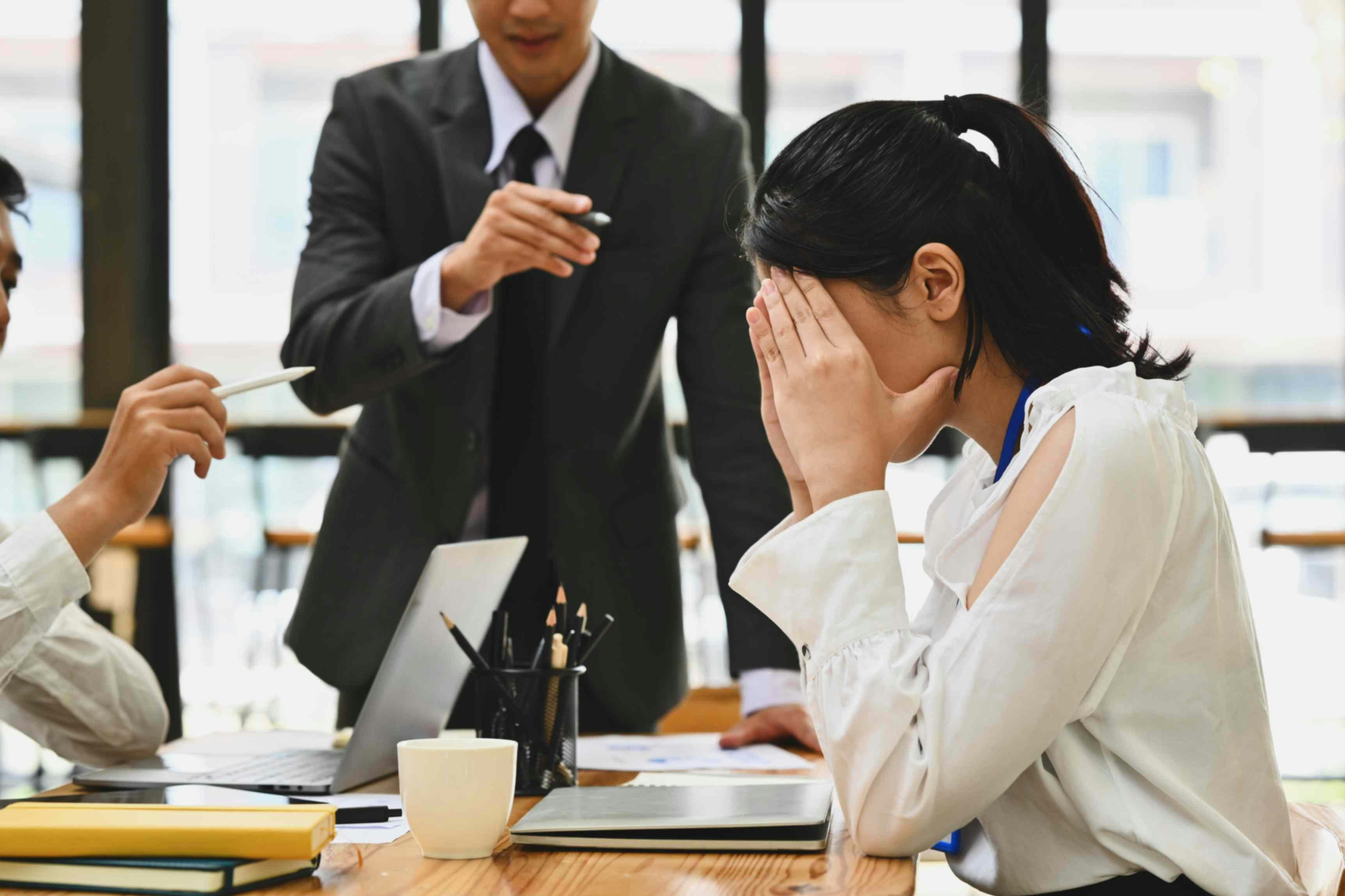 a female worker with her head in her hands