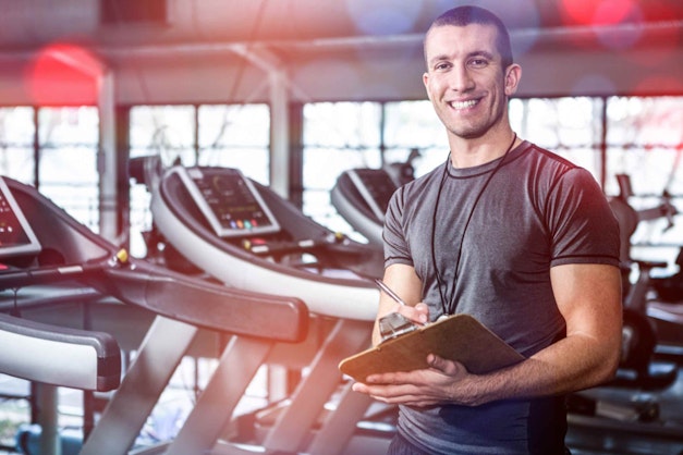 a man with a clipboard at a gym