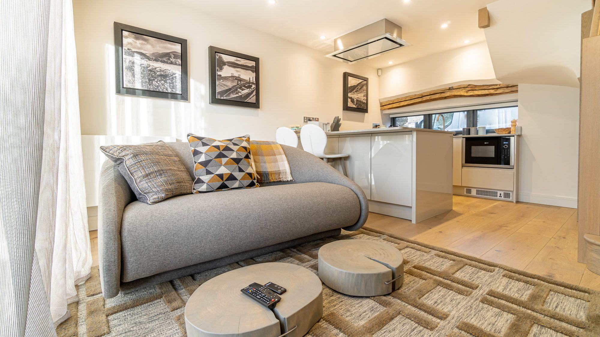 Kitchen and living room with gray couch.
