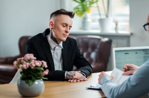 person with tattoos in interview