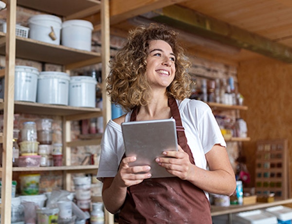 Shop owner holding a tablet