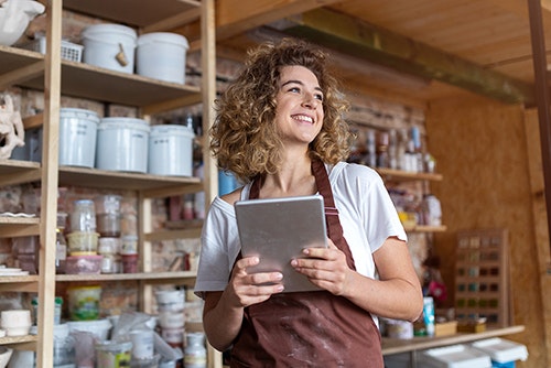 Shop owner holding a  tablet