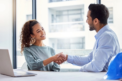 woman and man shaking hands