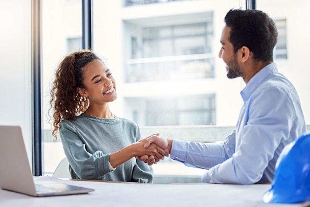 woman and man shaking hands