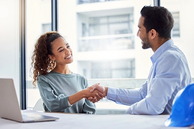woman and man shaking hands