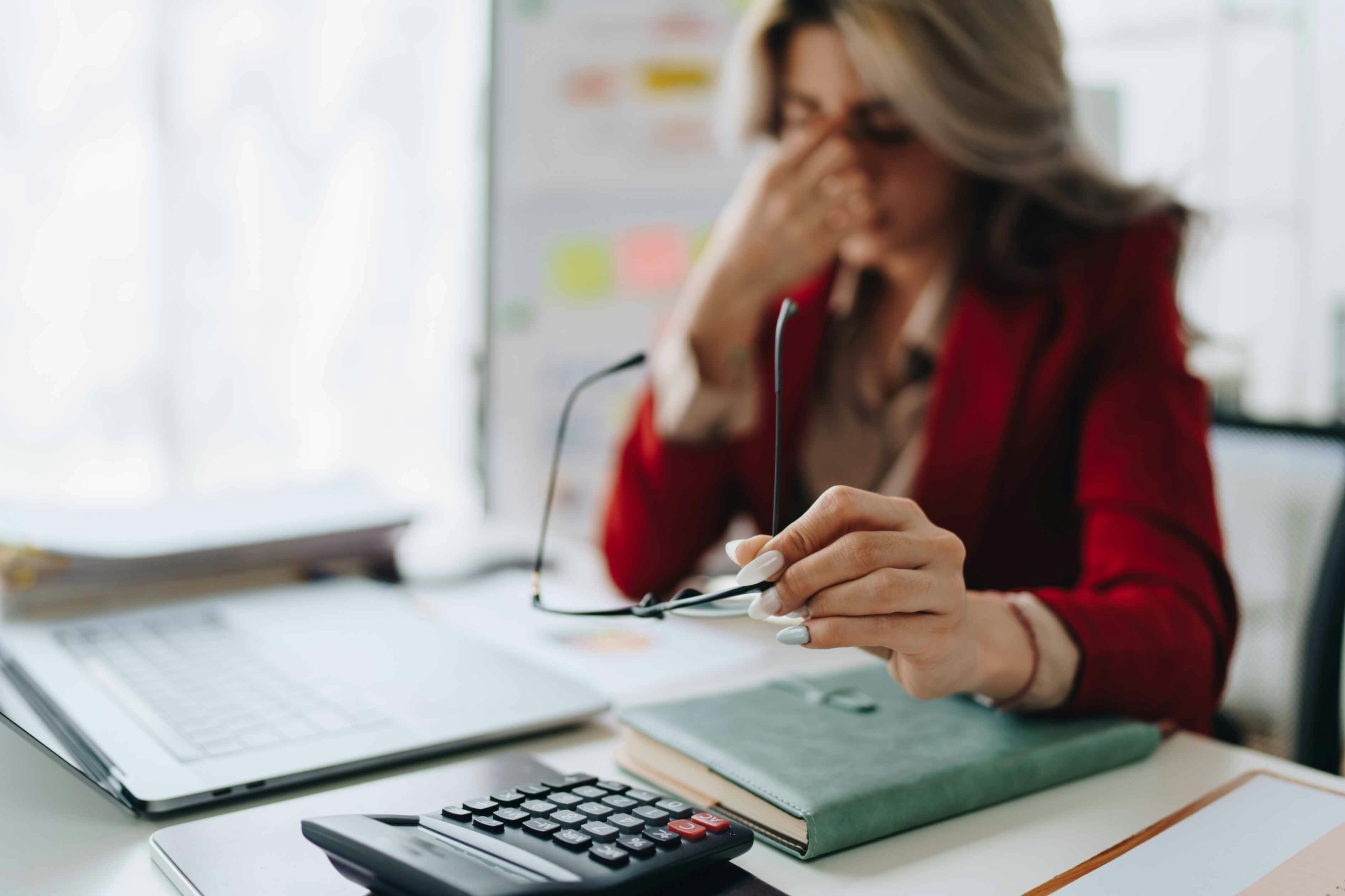 a distressed looking woman at a desk