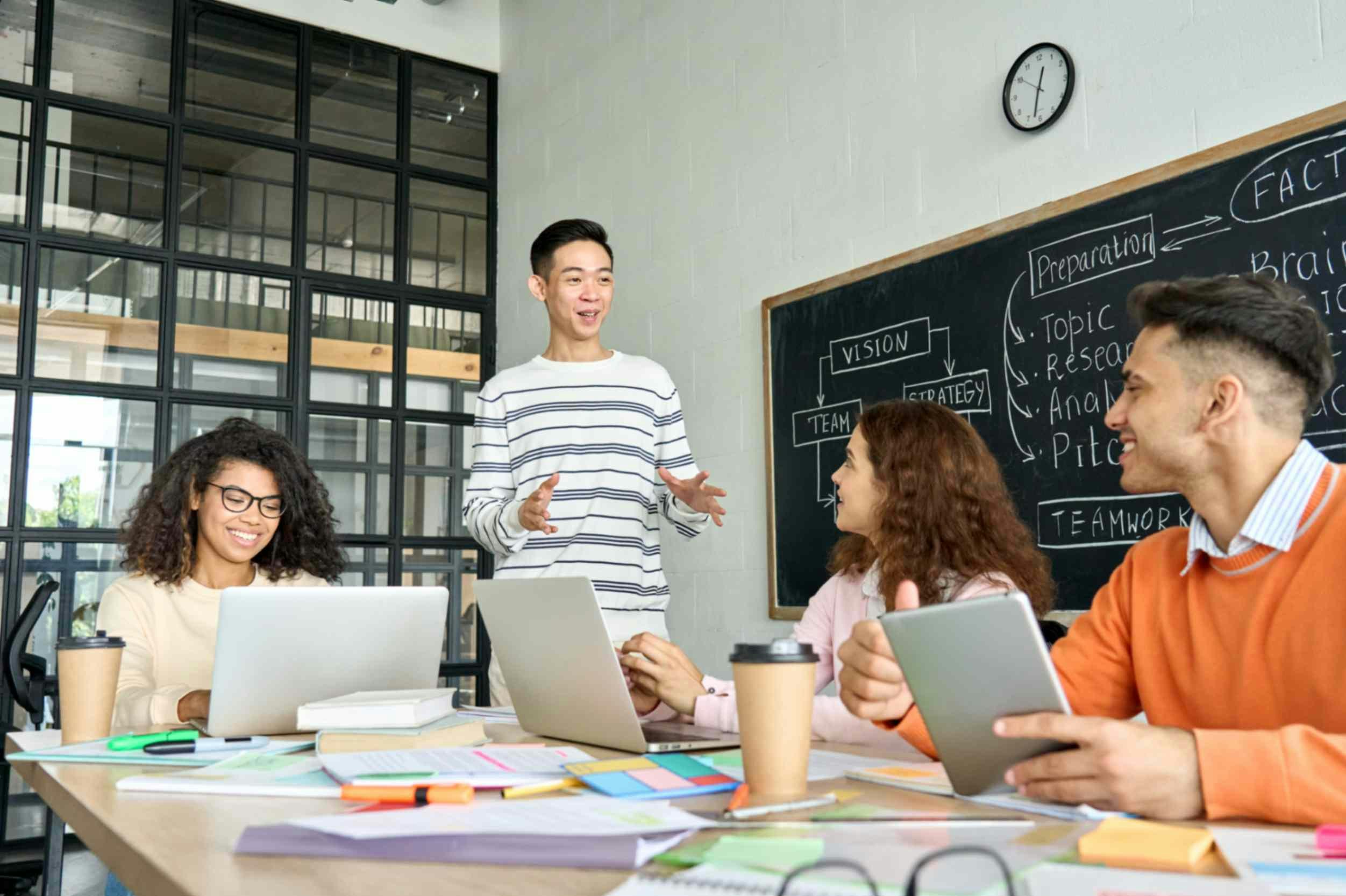 a group of people sat around a desk working