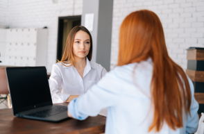 employees sat at desk with laptops