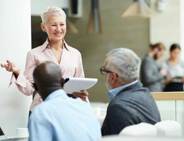 Woman talking to colleagues