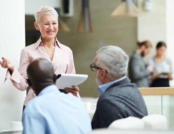 Woman talking to colleagues