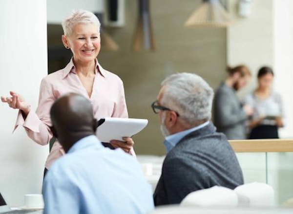 Woman talking to colleagues