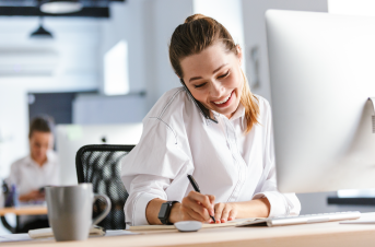 woman writing at desk