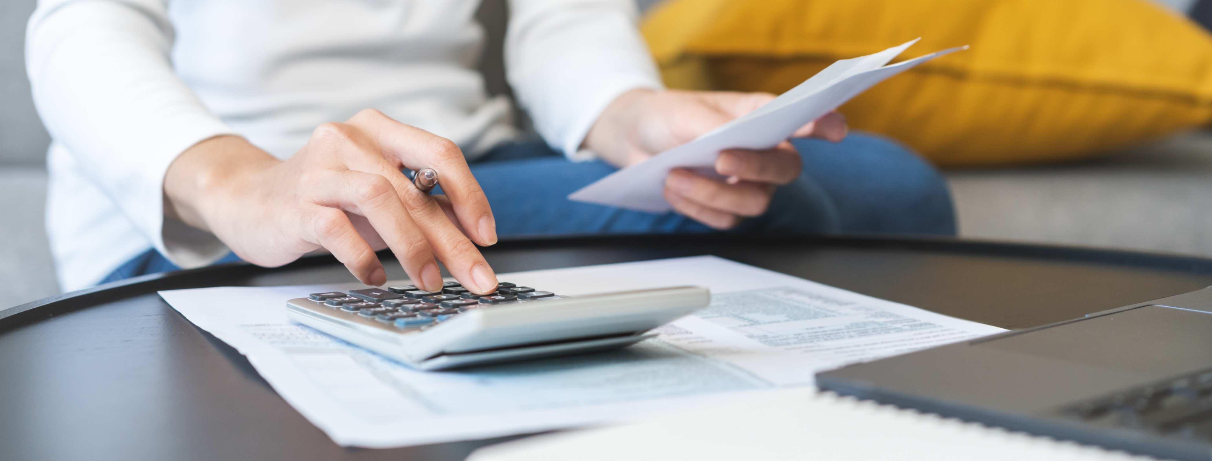a person typing on a calculator