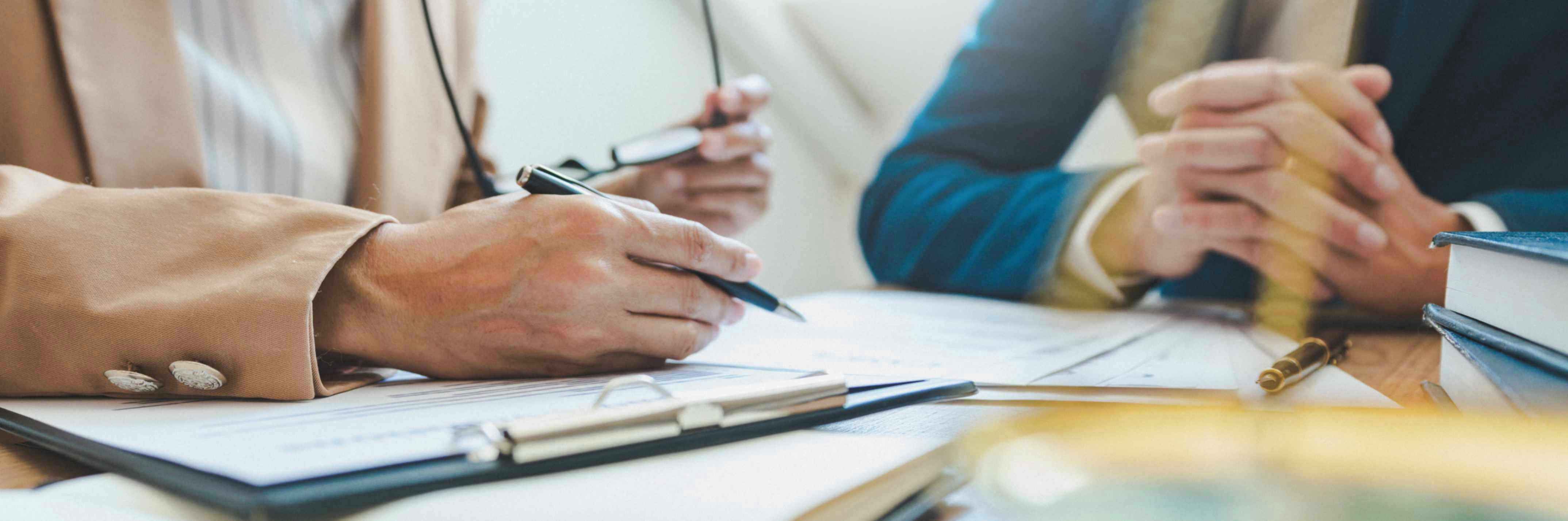 two people at a desk with documents