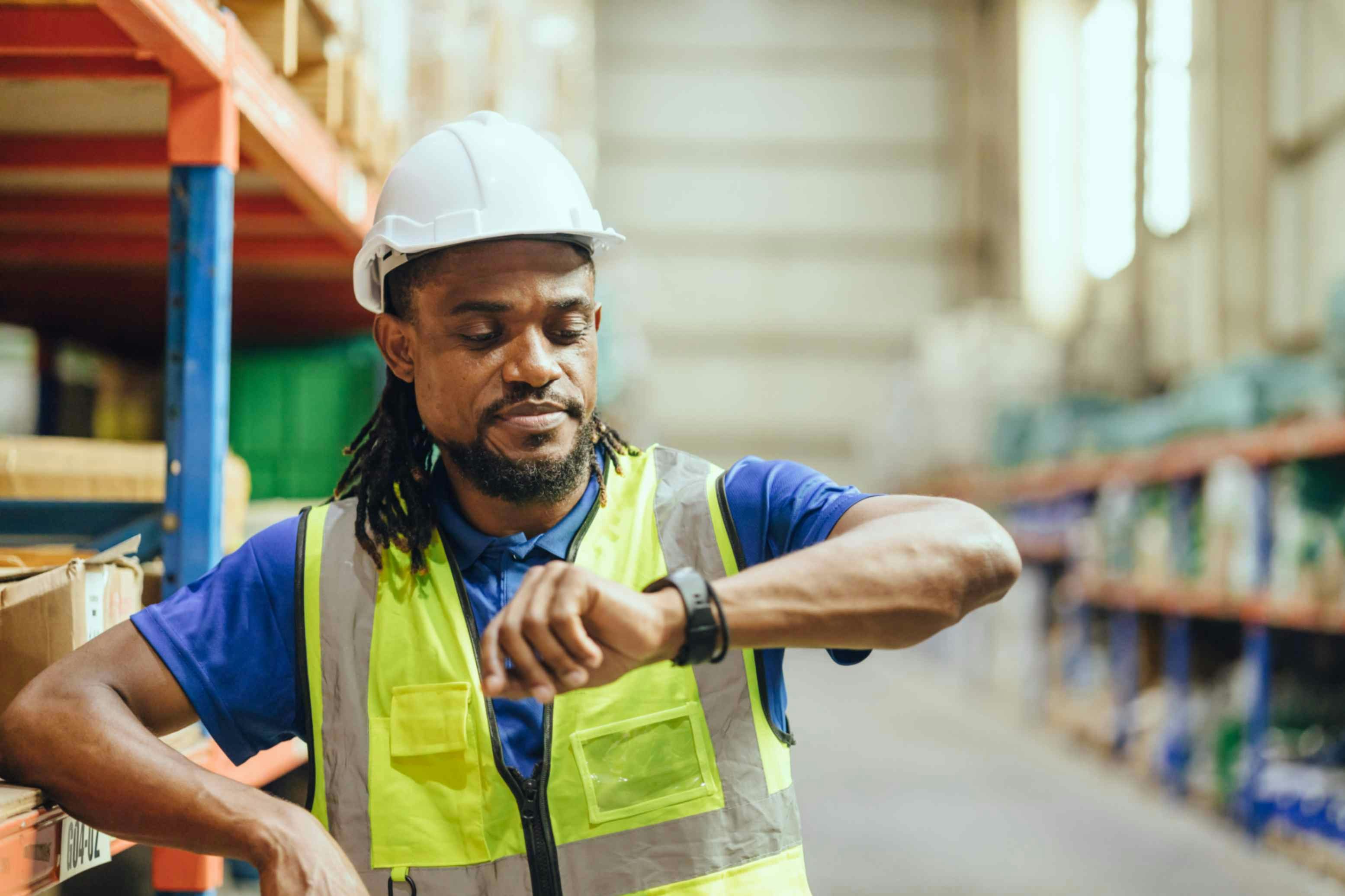 a man in high vis looking at his watch