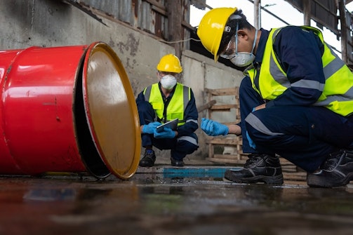 Workers inspecting contaminated water