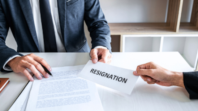 a man at a desk with documents