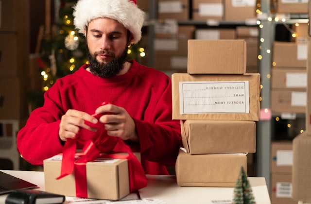 man wrapping presents