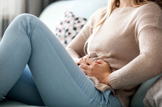 A woman clutching her stomach