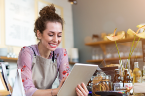 woman barista looking at tablet