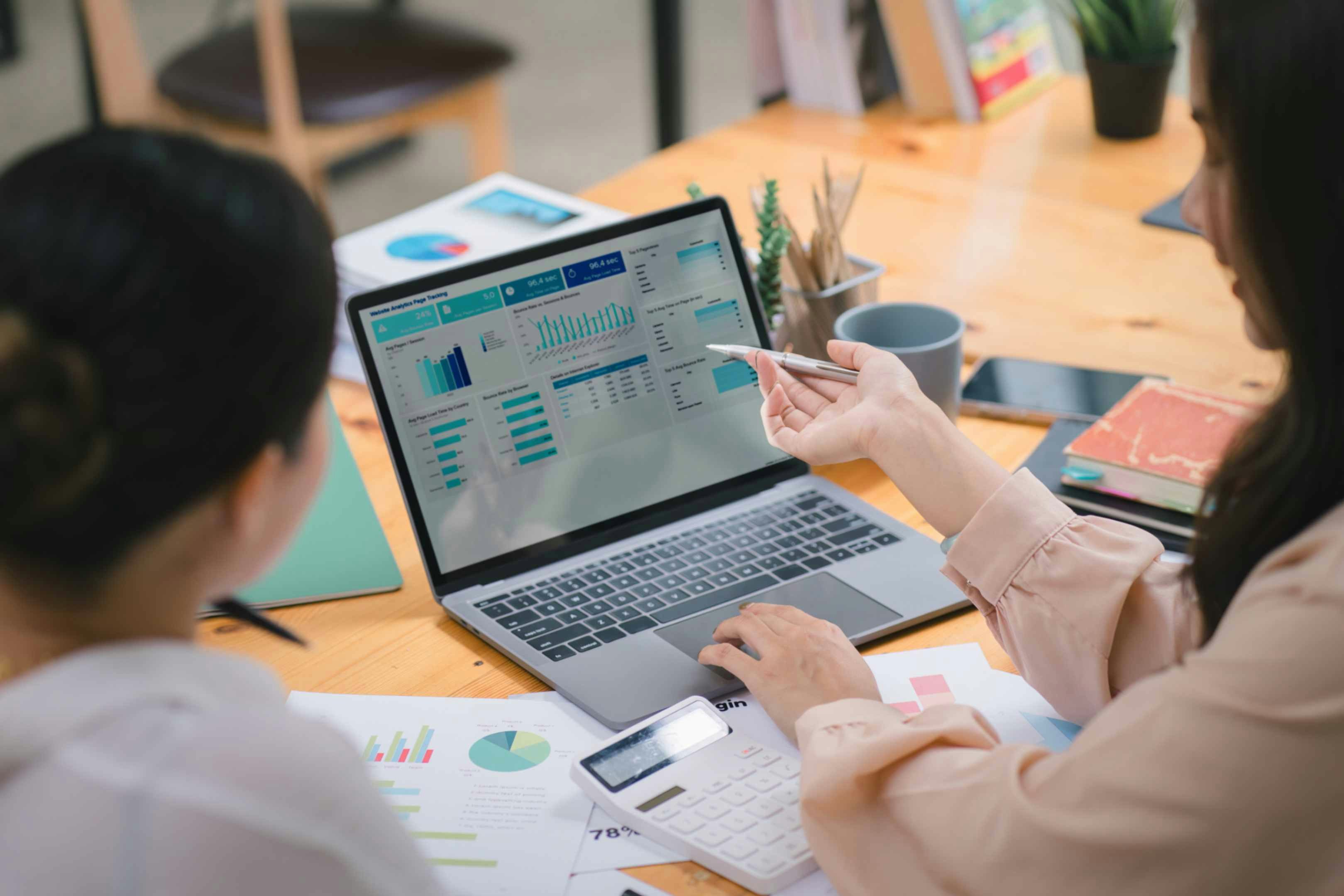two women looking at a laptop