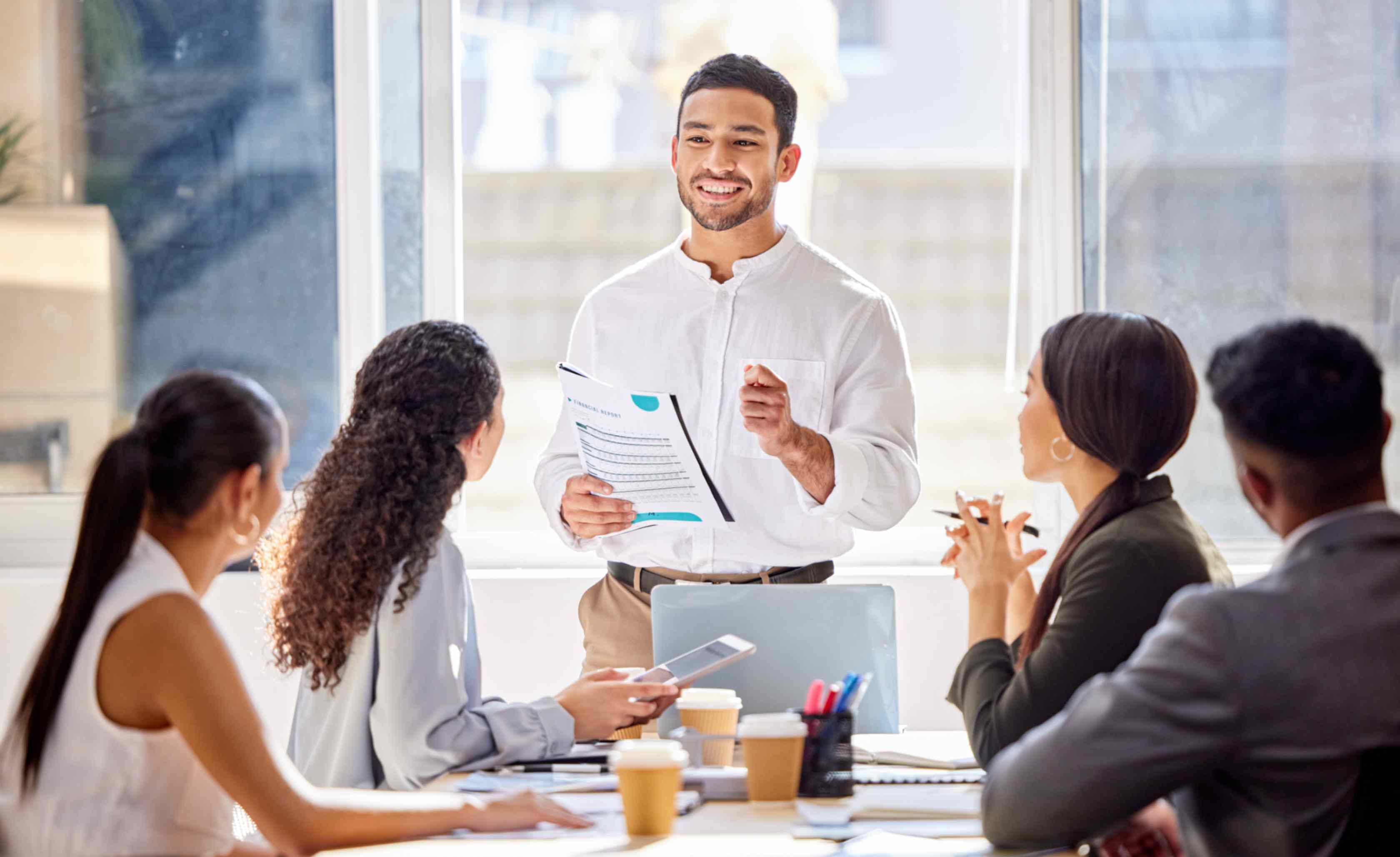 employees smiling round a desk