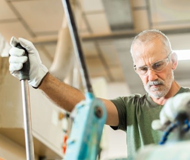 old worker working at a factory