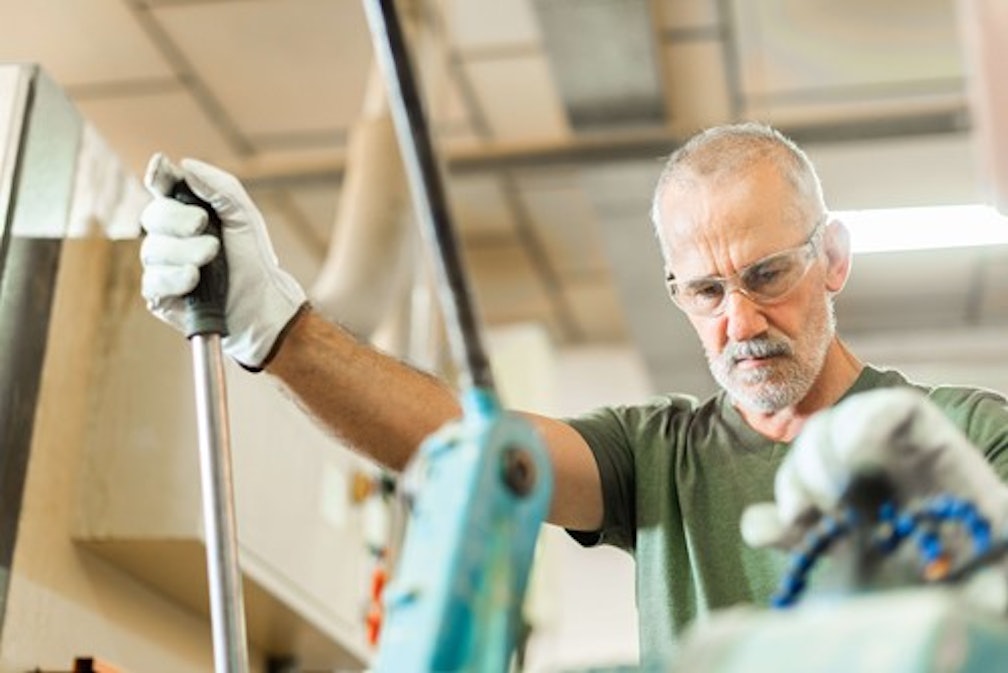 old worker working at a factory