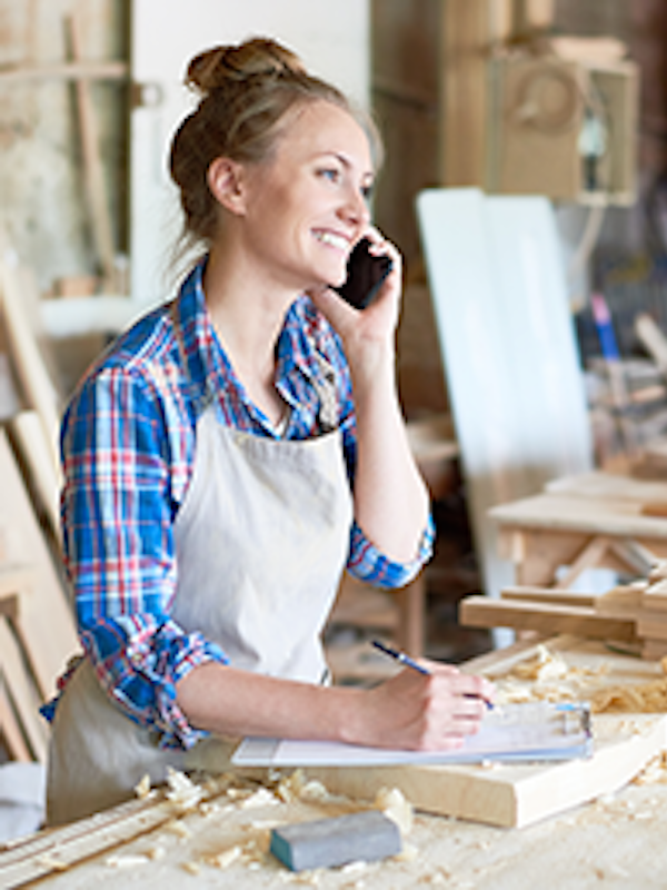 A business owner in a wood workshop.
