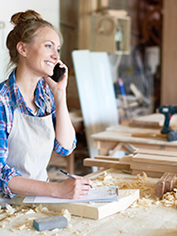 A business owner in a wood workshop.