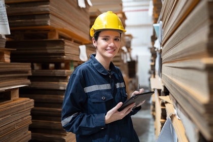 Female factory employee with iPad