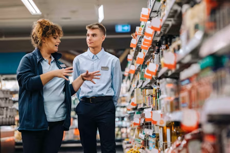 a man and woman in supermarket uniform