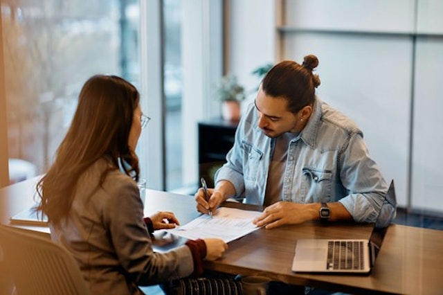 employer reviewing contracts