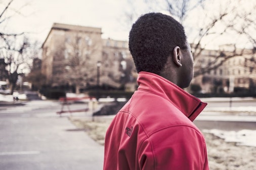 A young person wearing a red jacket.