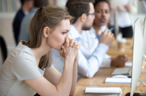 woman looking stressed at desk