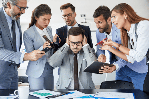 man looking overwhelmed by work obligations