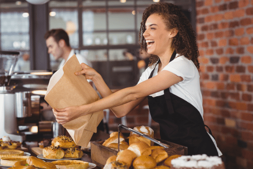 Female server handing food to customer
