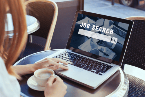 person searching for job on laptop
