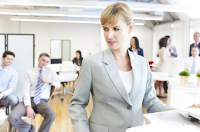 woman in suit being stared at by other men in suits