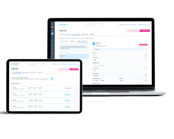 A laptop and tablet displaying payroll software