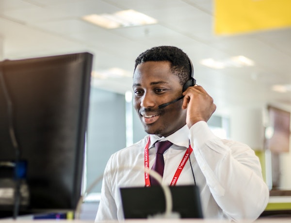 HR Management Software - An advisor talking on the phone.