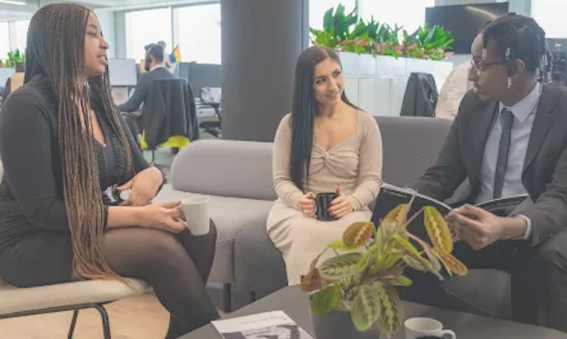Three people are having a meeting in an office.