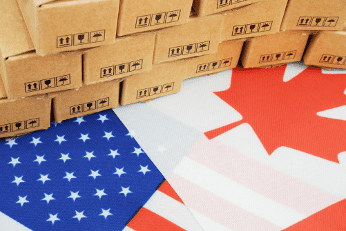 American (US) flag superphone by  Canadian flag with a pile of boxes on top