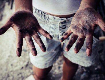 Child laborer with sooty hands